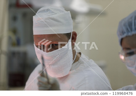 Doctors in a mask and hat in the operating room.A doctor who has a professional surgeon 119968476