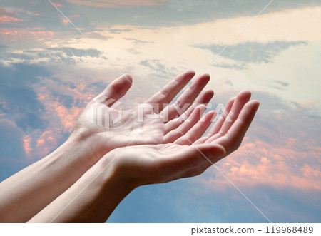 The outstretched hands of a praying man 119968489