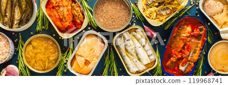 Enjoy an assortment of canned fish including salmon, mackerel, sprat, sardine, tuna, herring, and fish pate, displayed in open tins with spices and herbs on a blue background Enjoy an assortment of canned fish including salmon, mackerel, sprat, sardine, tuna, herring, and fish pate, displayed in open tins with spices and herbs on a blue background 119968741
