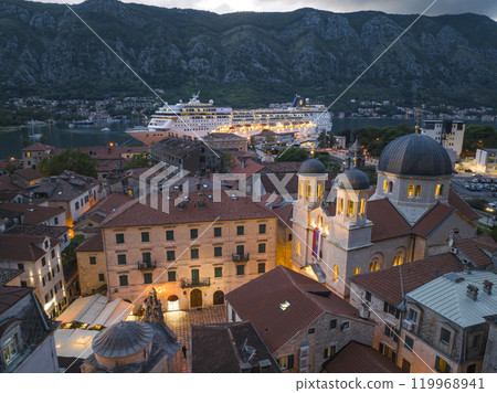 Big Cruise Ship in Kotor on the coast of Boka bay in Mediterranean, Montenegro. Destination in Europe. Aerial Big Cruise Ship in Kotor on the coast of Boka bay in Mediterranean, Montenegro. Destination in Europe. Aerial 119968941