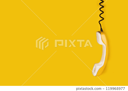 Yellow old phone handset dangles on wire. yellow background banner poster copy space photo Yellow old phone handset dangles on wire. yellow background banner poster copy space photo 119968977