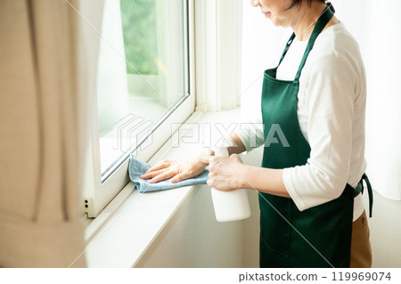 中高級婦女在家中清潔窗戶 中高級婦女在家中清潔窗戶 119969074