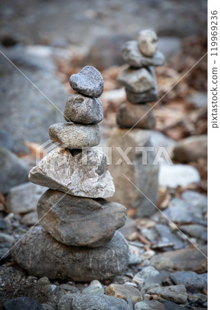 Stones piled up on the riverbank 119969236