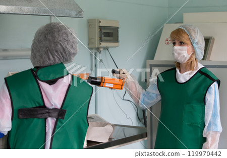 Nurses prepare radiation iodine for oncology treatment 119970442