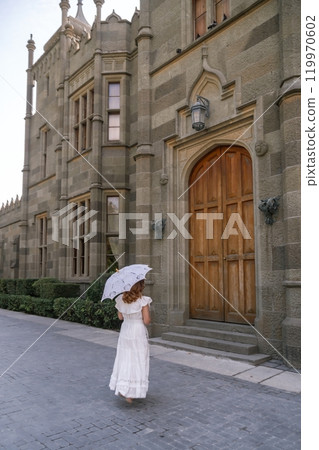 Palace Woman Azerbaijan - A woman walks towards a palace in Azerbaijan, carrying a white umbrella. 119970602