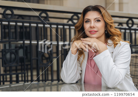 Woman, Portrait, Smiling - Attractive woman posing for a portrait outdoors. 119970654