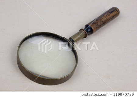 Antique magnifying glass on paper Antique magnifying glass on paper 119970759
