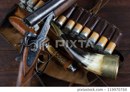 double barreled side shotgun with cartridges in bandolier. double barreled side shotgun with cartridges in bandolier. 119970788