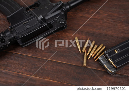 Rifle and Ammunition with magazine on wooden table 119970801