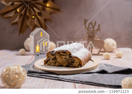Traditional German Christmas stollen cake in background of handmade festive decor. Winter holiday treats. Vegan baking recipe Traditional German Christmas stollen cake in background of handmade festive decor. Winter holiday treats. Vegan baking recipe 119971223