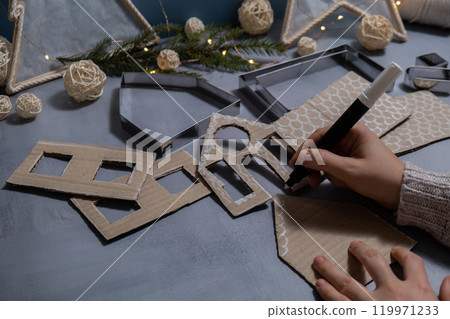 Cardboard House Gift Christmas idea. Do it yourself instruction eco-friendly decoration. Zero waste Making handmade presents children's diy projects. Holiday family time 119971233