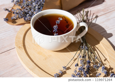 White cup of lavender tea. Mortars of dry lavender alternative medicine. Immunity boosting healthy herbal tea White cup of lavender tea. Mortars of dry lavender alternative medicine. Immunity boosting healthy herbal tea 119971264