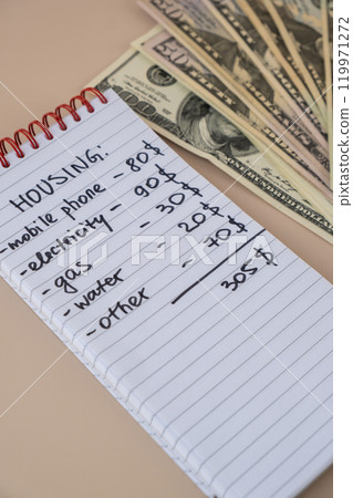 Counting receipt for utilities payment. Dollars cash money Electricity water gas price. Conservative consumption insecurity economic crisis concept. Increasing higher prices Counting receipt for utilities payment. Dollars cash money Electricity water gas price. Conservative consumption insecurity economic crisis concept. Increasing higher prices 119971272