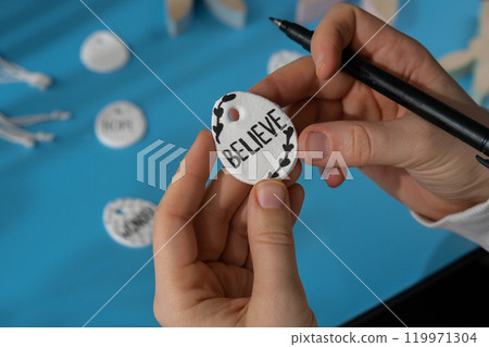 Workshop writing word BELIEVE on EASTER clay egg Children air dry clay activity handicraft idea. DIY process step by step instruction. Preparing for Easter holiday decorating. Modern organic design 119971304