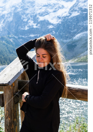 Young woman enjoying nature in Morskie Oko Snowy Mountain Hut in Polish Tatry mountains Zakopane Poland. Naturecore aesthetic beautiful green hills. Mental and physical wellbeing Travel outdoors Young woman enjoying nature in Morskie Oko Snowy Mountain Hut in Polish Tatry mountains Zakopane Poland. Naturecore aesthetic beautiful green hills. Mental and physical wellbeing Travel outdoors 119971352