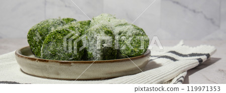 Frozen food spinach cubes homemade. Harvesting concept. Stocking up vegetables for winter storage Frozen food spinach cubes homemade. Harvesting concept. Stocking up vegetables for winter storage 119971353