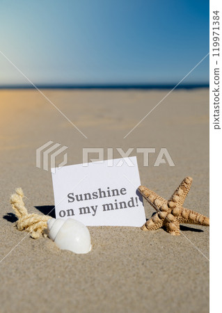 SUNSHINE ON MY MIND text on paper greeting card on background of starfish seashell summer vacation decor. Sandy beach sun coast. Holiday concept postcard. Getting away Travel SUNSHINE ON MY MIND text on paper greeting card on background of starfish seashell summer vacation decor. Sandy beach sun coast. Holiday concept postcard. Getting away Travel 119971384