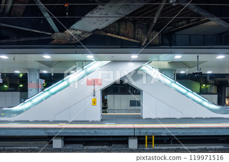 Modern illuminated double escalator on subway station in urban 119971516