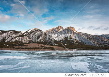 Rocky mountains on frozen lake in Abraham Lake Rocky mountains on frozen lake in Abraham Lake 119971558