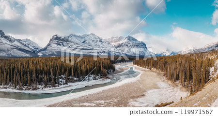 Landscape of rocky mountains and frozen fiver in pine forest at Kootenay plains area, Canada 119971567