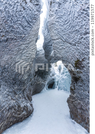 Ice cave with rock formation of water eroded on winter 119971577