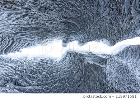 Ice cave with rock formation of water eroded on winter 119971581
