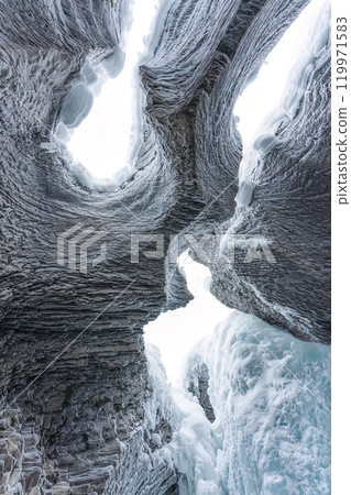 Ice cave with rock formation of water eroded on winter at Natural bridge, Yoho national park, Canada Ice cave with rock formation of water eroded on winter at Natural bridge, Yoho national park, Canada 119971583