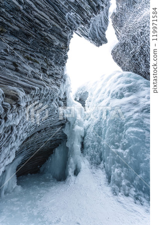 Ice cave with rock formation of water eroded on winter Ice cave with rock formation of water eroded on winter 119971584