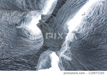 Ice cave with rock formation of water eroded on winter 119971585