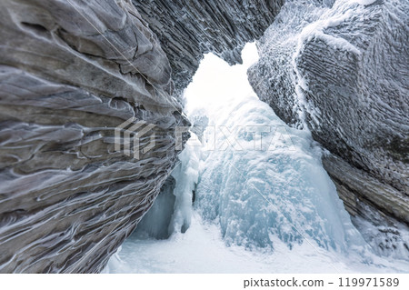 Ice cave with rock formation of water eroded on winter 119971589