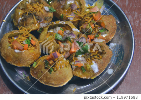 A plate of vibrant panipuri, a popular nepali street snack, filled with spicy and savory ingredients 119971688
