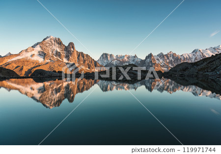 Lac Blanc with Mont Blanc massif and mountain goat walking reflected on lake in the sunset 119971744