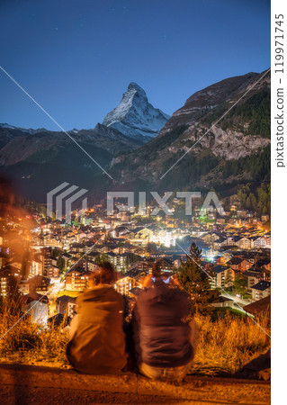 Viewpoint of tourist couple enjoying with Zermatt village and Matterhorn mountain at Switzerland Viewpoint of tourist couple enjoying with Zermatt village and Matterhorn mountain at Switzerland 119971745