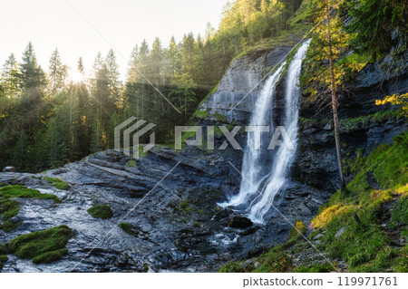Cascade du Rouget waterfall flowing with sunshine in tropical forest at Sixt fer a cheval, France Cascade du Rouget waterfall flowing with sunshine in tropical forest at Sixt fer a cheval, France 119971761
