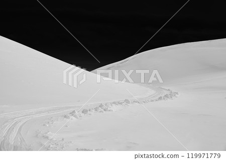 White glacier mountain with snow covered and black sky, snowmobile track on summit in winter White glacier mountain with snow covered and black sky, snowmobile track on summit in winter 119971779