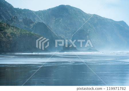 Seascape of Bethells Beach with mountain cape and wave in gloomy day at New Zealand 119971782