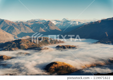 Scenic foggy mountain from summit of Roys Peak with Lake Wanaka in the morning at New Zealand Scenic foggy mountain from summit of Roys Peak with Lake Wanaka in the morning at New Zealand 119971822
