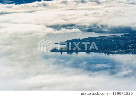 Scenic foggy mountain from summit of Roys Peak with Lake Wanaka in the morning at New Zealand Scenic foggy mountain from summit of Roys Peak with Lake Wanaka in the morning at New Zealand 119971826