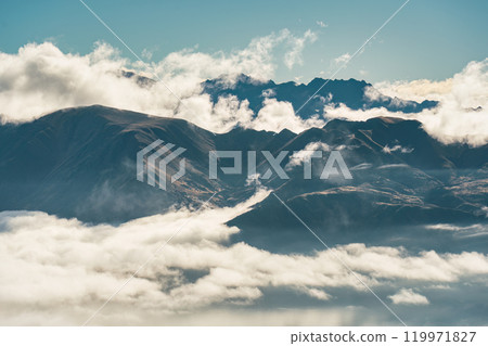 Scenic foggy mountain from summit of Roys Peak with Lake Wanaka in the morning at New Zealand 119971827