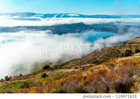 Scenic foggy mountain view from summit of Roys Peak and Lake Wanaka in autumn at New Zealand Scenic foggy mountain view from summit of Roys Peak and Lake Wanaka in autumn at New Zealand 119971828