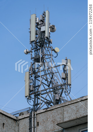 Antenna on the roof of the house with many radio transmitters. Antennas of communication in the city. Antenna on the roof of the house with many radio transmitters. Antennas of communication in the city. 119972268