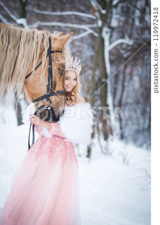 Princess in crown with horse in winter. Fairy tale, snowy queen Princess in crown with horse in winter. Fairy tale, snowy queen 119972418