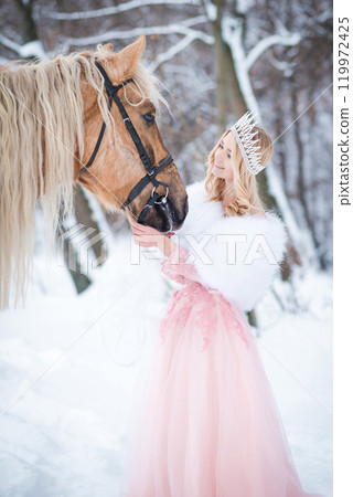 Princess in crown with horse in winter. Fairy tale, snowy queen 119972425