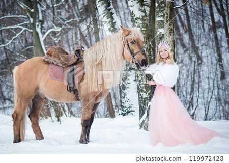 Princess in crown with horse in winter. Fairy tale, snowy queen Princess in crown with horse in winter. Fairy tale, snowy queen 119972428