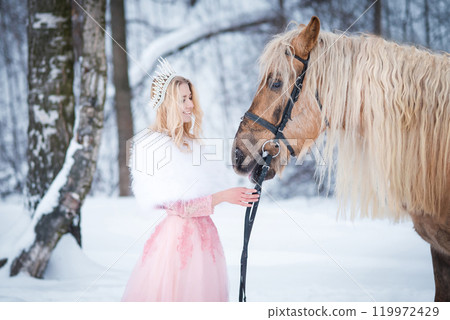 Princess in crown with horse in winter. Fairy tale, snowy queen Princess in crown with horse in winter. Fairy tale, snowy queen 119972429