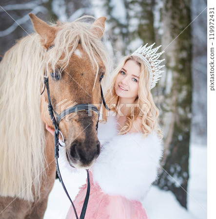 Princess in crown with horse in winter. Fairy tale, snowy queen Princess in crown with horse in winter. Fairy tale, snowy queen 119972431