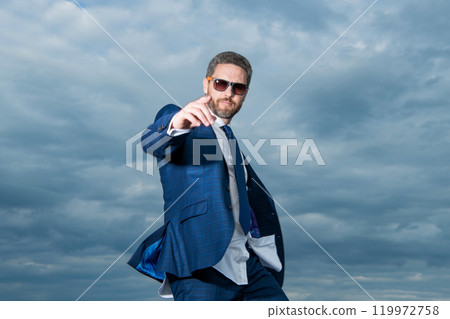 photo of carefree business man pointing finger in suit. carefree business man in suit photo of carefree business man pointing finger in suit. carefree business man in suit 119972758