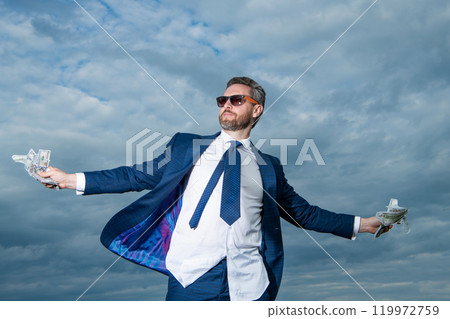 carefree millionaire man with money outdoor. millionaire man with money in suit. carefree millionaire man with money outdoor. millionaire man with money in suit. 119972759