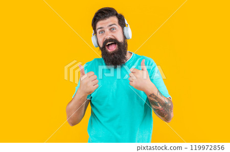 surprised dj guy in music headphones isolated on yellow background. dj guy wearing music headphones 119972856
