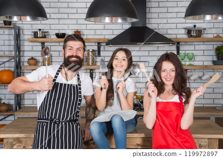 father and mother with daughter cook in kitchen. little girl cooking with parents. love and support. healthy food concept. professional chef team. happy childhood. happy family day. A lot of work father and mother with daughter cook in kitchen. little girl cooking with parents. love and support. healthy food concept. professional chef team. happy childhood. happy family day. A lot of work 119972897